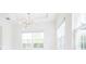Bright bedroom with a modern light fixture and large windows at 2604 Meadowedge Loop, St Cloud, FL 34772
