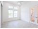 Bright bedroom with tiled flooring and natural light from large windows and glass paneled door at 2604 Meadowedge Loop, St Cloud, FL 34772