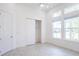 Bright bedroom with tiled flooring, closet, and natural light from three large windows at 2604 Meadowedge Loop, St Cloud, FL 34772