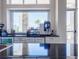 Coffee bar features stone pillars with granite countertops with a window view of tropical palm trees at 2604 Meadowedge Loop, St Cloud, FL 34772