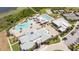 Aerial view of community pool, tennis courts, clubhouse, and well-kept landscaping at 2604 Meadowedge Loop, St Cloud, FL 34772