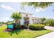 Charming exterior featuring mature landscaping, a paver walkway, and neutral paint at 2604 Meadowedge Loop, St Cloud, FL 34772