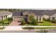 Beautiful one-story home with a well-manicured lawn, brick driveway, and a two-car garage at 2604 Meadowedge Loop, St Cloud, FL 34772