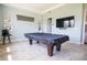 Spacious game room featuring a pool table, large flat screen television, and neutral wall paint at 2604 Meadowedge Loop, St Cloud, FL 34772