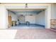Spacious two-car garage with brick flooring, overhead lighting, and ample storage space at 2604 Meadowedge Loop, St Cloud, FL 34772