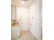 Clean and bright hallway featuring tile flooring, white walls and granite countertops at 2604 Meadowedge Loop, St Cloud, FL 34772