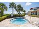 Relax in this community hot tub surrounded by lush landscaping and swaying palm trees at 2604 Meadowedge Loop, St Cloud, FL 34772