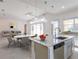 Open concept kitchen and dining area with granite countertops and stainless steel appliances at 2604 Meadowedge Loop, St Cloud, FL 34772