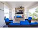 Outdoor living space with stone fireplace, ceiling fan, and comfortable blue lounge seating at 2604 Meadowedge Loop, St Cloud, FL 34772