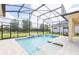 Sparkling pool surrounded by a screened enclosure and beautiful landscaping at 2604 Meadowedge Loop, St Cloud, FL 34772