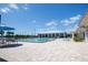 Community pool on a sunny day surrounded by lounge chairs and overlooking the landscape at 2604 Meadowedge Loop, St Cloud, FL 34772