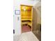 Relaxing sauna room with wooden benches, tiled floor, and temperature controls at 2604 Meadowedge Loop, St Cloud, FL 34772