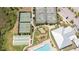 Aerial view of tennis and bocce ball courts, pool, clubhouse, and manicured landscaping at 2604 Meadowedge Loop, St Cloud, FL 34772