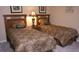 This bedroom features two beds with wooden headboards and a nightstand at 2605 Daulby St, Kissimmee, FL 34747