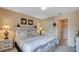 Bedroom with carpet floors, a white headboard, and an ensuite bathroom at 2605 Daulby St, Kissimmee, FL 34747