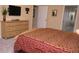 Bedroom featuring carpet floors, a dresser, and wall-mounted television at 2605 Daulby St, Kissimmee, FL 34747