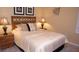 Bedroom featuring carpet floors, neutral walls, and a wrought-iron-style headboard at 2605 Daulby St, Kissimmee, FL 34747