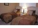 Bedroom with carpet floors, two twin beds, and bedside table with lamp at 2605 Daulby St, Kissimmee, FL 34747