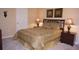 Bedroom with a carpet floor, a dark wooden headboard, and neutral colored walls at 2605 Daulby St, Kissimmee, FL 34747