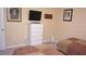 This cozy bedroom features two twin beds, a TV, and a dresser at 2605 Daulby St, Kissimmee, FL 34747