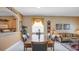 Spacious dining and living area with white tile flooring, neutral decor, and breakfast bar at 2605 Daulby St, Kissimmee, FL 34747
