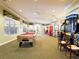 Bright game room with billiard table, large windows, and recreational games, offering entertainment for all at 2605 Daulby St, Kissimmee, FL 34747