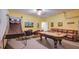 Spacious game room with a pool table, basketball game, and comfortable seating at 2605 Daulby St, Kissimmee, FL 34747