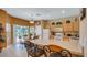 Bright kitchen with breakfast bar, tiled floors, white appliances, and sliding door access to the pool at 2605 Daulby St, Kissimmee, FL 34747