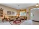 Well-lit living room features neutral tones, elegant decor, and white tile flooring at 2605 Daulby St, Kissimmee, FL 34747