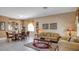 Spacious living room and dining area with white tile flooring and neutral decor at 2605 Daulby St, Kissimmee, FL 34747
