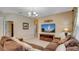 Comfortable living room with large TV, tile floors, and plenty of seating at 2605 Daulby St, Kissimmee, FL 34747