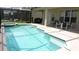 Inviting screened-in pool area with attached jacuzzi and outdoor seating at 2605 Daulby St, Kissimmee, FL 34747