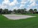 Sandy community volleyball court with lush green surroundings, perfect for outdoor recreation and games at 2605 Daulby St, Kissimmee, FL 34747