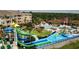 Aerial view of a waterpark with a pool, waterslides, and splash pad at 2605 Daulby St, Kissimmee, FL 34747