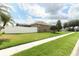 Manicured lawn and backyard featuring a screened patio, fenced for privacy, and landscaping that enhances curb appeal at 2752 Bellewater Pl, Oviedo, FL 32765