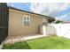Exterior view of backyard with small patio, storage bin, green lawn, and privacy fence at 2752 Bellewater Pl, Oviedo, FL 32765