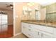 Bathroom featuring double vanity with granite countertop and access to bedroom and screened lanai at 2752 Bellewater Pl, Oviedo, FL 32765