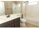 Bright bathroom featuring a shower-tub combo and modern vanity with solid surface countertops at 2752 Bellewater Pl, Oviedo, FL 32765