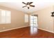 Bright bedroom with hardwood floors, a ceiling fan, and sliding door access to the patio at 2752 Bellewater Pl, Oviedo, FL 32765