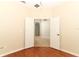 Bedroom with rich wood floors and double doors to another room at 2752 Bellewater Pl, Oviedo, FL 32765