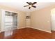 Spacious bedroom with hardwood floors, ceiling fan, and sliding glass doors to the screened patio at 2752 Bellewater Pl, Oviedo, FL 32765