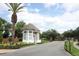 Guarded community entrance with manicured landscaping and a palm tree, ensuring privacy and security for residents at 2752 Bellewater Pl, Oviedo, FL 32765