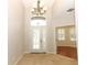 Bright foyer with high ceilings, tile flooring, and a decorative chandelier at 2752 Bellewater Pl, Oviedo, FL 32765