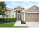 Charming home featuring a well-manicured lawn and a two car garage at 2752 Bellewater Pl, Oviedo, FL 32765