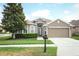 Well maintained home with manicured lawn, mature tree, and a two car garage at 2752 Bellewater Pl, Oviedo, FL 32765