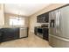 Full kitchen with stainless steel appliances, granite countertops and tile flooring at 2752 Bellewater Pl, Oviedo, FL 32765
