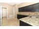 Well-lit kitchen with granite countertops, tiled floor, and modern cabinetry at 2752 Bellewater Pl, Oviedo, FL 32765