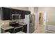 Modern kitchen boasts stainless steel appliances and granite countertops with lots of storage space at 2752 Bellewater Pl, Oviedo, FL 32765