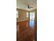 Bright living room featuring hardwood floors, plantation shutters, and sliding glass doors at 2752 Bellewater Pl, Oviedo, FL 32765