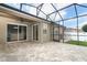 Covered patio with brick pavers, screened-in enclosure, and access to backyard and house at 2752 Bellewater Pl, Oviedo, FL 32765
